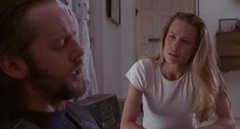Movie still from “The Crossing Guard” (1995), directed by Sean Penn – A man and a woman sitting in a living room; Close Up shot, Over the shoulder angle