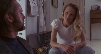 Movie still from “The Crossing Guard” (1995), directed by Sean Penn – A woman sitting next to a man in front of a radio; Medium shot, Over the shoulder angle