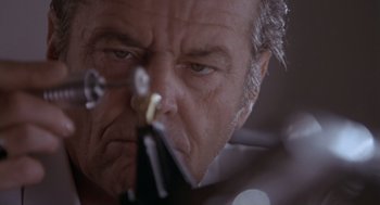 Movie still from “The Crossing Guard” (1995), directed by Sean Penn – An older man holding a pair of scissors in front of his face; Extreme Close Up shot, Low angle