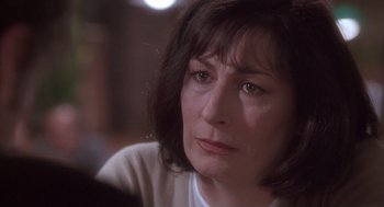 Movie still from “The Crossing Guard” (1995), directed by Sean Penn – A person sitting in front of a camera; Close Up shot, Over the shoulder angle