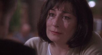 Movie still from “The Crossing Guard” (1995), directed by Sean Penn – A person with a crying face; Close Up shot, Over the shoulder angle
