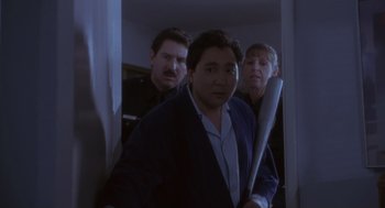 Movie still from “The Crossing Guard” (1995), directed by Sean Penn – A group of men standing next to each other holding baseball bats; Medium shot, Over the shoulder angle