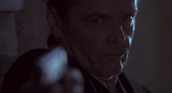 Movie still from “The Crossing Guard” (1995), directed by Sean Penn – A person holding a gun; Close Up shot, Low angle