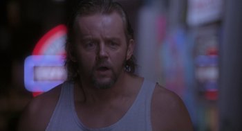 Movie still from “The Crossing Guard” (1995), directed by Sean Penn – A person wearing a tank top; Close Up shot, Low angle