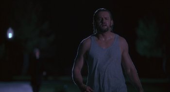 Movie still from “The Crossing Guard” (1995), directed by Sean Penn – A man in a tank top is running in the dark; Medium shot, Low angle
