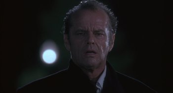 Movie still from “The Crossing Guard” (1995), directed by Sean Penn – A person wearing a suit and tie; Close Up shot, Low angle