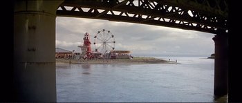 Movie still from “The Crying Game” (1992), directed by Neil Jordan – A view of a ferris wheel from the water; Extreme Wide shot, High angle