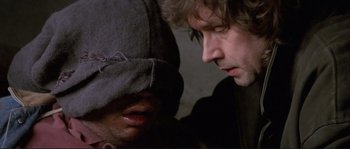Movie still from “The Crying Game” (1992), directed by Neil Jordan – A man and a woman looking at one another; Close Up shot, Over the shoulder angle