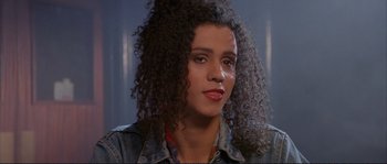 Movie still from “The Crying Game” (1992), directed by Neil Jordan – A person with curly black hair; Close Up shot, Over the shoulder angle