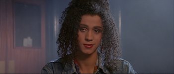 Movie still from “The Crying Game” (1992), directed by Neil Jordan – A person with curly black hair; Close Up shot, High angle