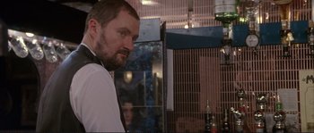 Movie still from “The Crying Game” (1992), directed by Neil Jordan – A person wearing a suit and tie; Close Up shot, Over the shoulder angle