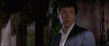 Movie still from “The Crying Game” (1992), directed by Neil Jordan – A person wearing a suit and tie; Close Up shot, Low angle