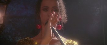 Movie still from “The Crying Game” (1992), directed by Neil Jordan – A person holding a microphone up to their face; Close Up shot, Low angle