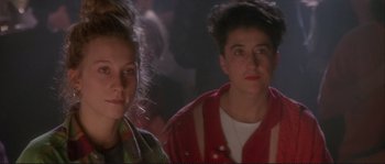 Movie still from “The Crying Game” (1992), directed by Neil Jordan – Two women are standing next to each other in a room; Close Up shot, Low angle