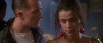 Movie still from “The Crying Game” (1992), directed by Neil Jordan – A man and a woman are standing next to each other; Close Up shot, Over the shoulder angle