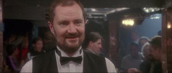 Movie still from “The Crying Game” (1992), directed by Neil Jordan – A person wearing a bow tie; Close Up shot, Over the shoulder angle