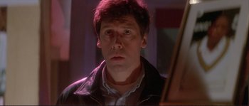 Movie still from “The Crying Game” (1992), directed by Neil Jordan – A person wearing a jacket; Close Up shot, Low angle