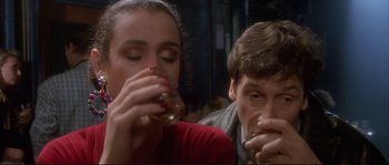 Movie still from “The Crying Game” (1992), directed by Neil Jordan – A man and a woman drinking wine at a restaurant; Close Up shot, High angle