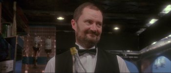 Movie still from “The Crying Game” (1992), directed by Neil Jordan – A person wearing a vest and a bow tie; Close Up shot, Low angle