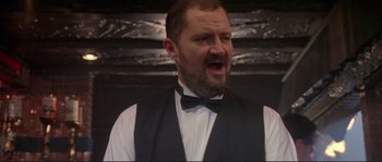 Movie still from “The Crying Game” (1992), directed by Neil Jordan – A man wearing a black bow tie and a white shirt; Close Up shot, Low angle