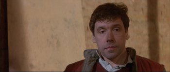 Movie still from “The Crying Game” (1992), directed by Neil Jordan – A person wearing a jacket; Close Up shot, Low angle