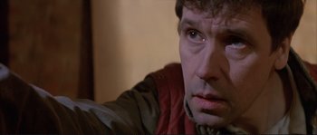 Movie still from “The Crying Game” (1992), directed by Neil Jordan – A man's face as he stares into the camera; Close Up shot, Over the shoulder angle