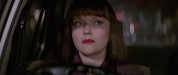 Movie still from “The Crying Game” (1992), directed by Neil Jordan – A person sitting in a car holding a steering wheel; Close Up shot, Over the shoulder angle