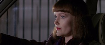 Movie still from “The Crying Game” (1992), directed by Neil Jordan – A person sitting down; Close Up shot, Low angle