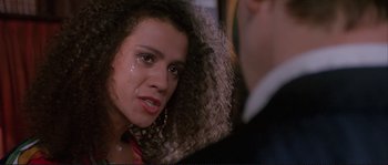 Movie still from “The Crying Game” (1992), directed by Neil Jordan – A person with curly hair; Close Up shot, Over the shoulder angle