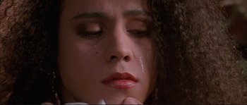 Movie still from “The Crying Game” (1992), directed by Neil Jordan – A person with a tear in her eye; Close Up shot, High angle