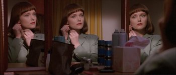 Movie still from “The Crying Game” (1992), directed by Neil Jordan – A woman sitting in front of a mirror; Close Up shot, Over the shoulder angle