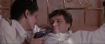 Movie still from “The Crying Game” (1992), directed by Neil Jordan – A woman is holding a gun up to a man's face; Close Up shot, Low angle