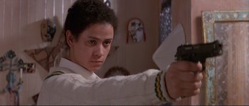 Movie still from “The Crying Game” (1992), directed by Neil Jordan – A young man in a white shirt is holding a white object; Close Up shot, Low angle