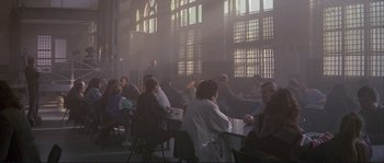 Movie still from “The Crying Game” (1992), directed by Neil Jordan – A group of people sitting at a table in front of a window; Wide shot, High angle