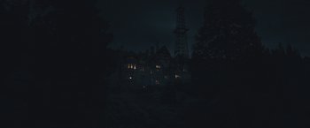 Movie still from “The Current War: Director's Cut” (2017), directed by Alfonso Gomez-Rejon – A dark picture of a house in the dark; Extreme Wide shot, High angle