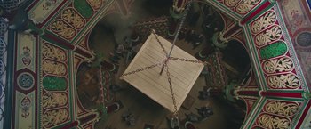 Movie still from “The Current War: Director's Cut” (2017), directed by Alfonso Gomez-Rejon – An overhead view of a wooden box with chains hanging from it; Extreme Wide shot, Overhead angle