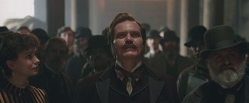 Movie still from “The Current War: Director's Cut” (2017), directed by Alfonso Gomez-Rejon – A man that is wearing a suit and a tie; Close Up shot, Low angle