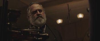 Movie still from “The Current War: Director's Cut” (2017), directed by Alfonso Gomez-Rejon – An old man with a beard and a tie; Close Up shot, Low angle