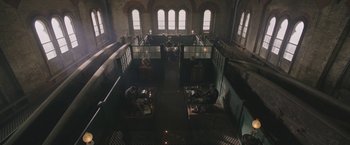 Movie still from “The Current War: Director's Cut” (2017), directed by Alfonso Gomez-Rejon – A group of people sitting at tables in a room; Extreme Wide shot, High angle