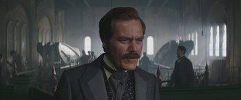 Movie still from “The Current War: Director's Cut” (2017), directed by Alfonso Gomez-Rejon – A person wearing a suit and tie; Close Up shot, Low angle