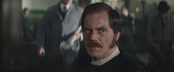 Movie still from “The Current War: Director's Cut” (2017), directed by Alfonso Gomez-Rejon – A person with a beard and a mustache; Close Up shot, Over the shoulder angle