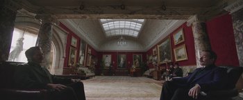Movie still from “The Current War: Director's Cut” (2017), directed by Alfonso Gomez-Rejon – A room filled with furniture and paintings on the walls; Wide shot, Low angle