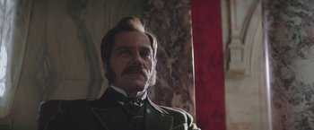 Movie still from “The Current War: Director's Cut” (2017), directed by Alfonso Gomez-Rejon – A person wearing a suit and tie; Close Up shot, Low angle