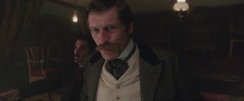 Movie still from “The Current War: Director's Cut” (2017), directed by Alfonso Gomez-Rejon – A person wearing a suit and tie; Close Up shot, Low angle