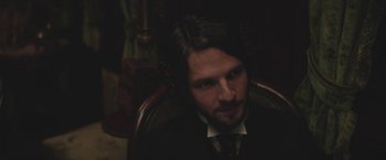 Movie still from “The Current War: Director's Cut” (2017), directed by Alfonso Gomez-Rejon – A person wearing a suit and tie; Close Up shot, Over the shoulder angle