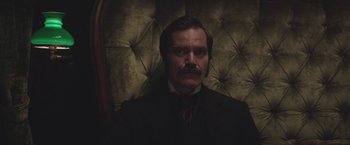 Movie still from “The Current War: Director's Cut” (2017), directed by Alfonso Gomez-Rejon – A man in a suit and a tie; Close Up shot, Low angle