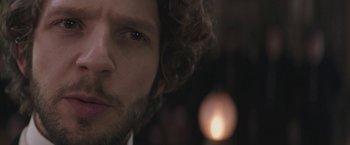 Movie still from “The Current War: Director's Cut” (2017), directed by Alfonso Gomez-Rejon – A man's face with a blurry background; Extreme Close Up shot, Low angle