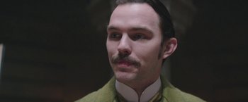 Movie still from “The Current War: Director's Cut” (2017), directed by Alfonso Gomez-Rejon – A person with a mustache wearing a suit; Close Up shot, Low angle