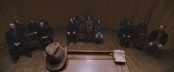 Movie still from “The Current War: Director's Cut” (2017), directed by Alfonso Gomez-Rejon – A group of men sitting on chairs in a room; Wide shot, High angle