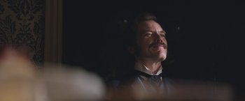 Movie still from “The Current War: Director's Cut” (2017), directed by Alfonso Gomez-Rejon – A person wearing a suit and tie; Close Up shot, Over the shoulder angle